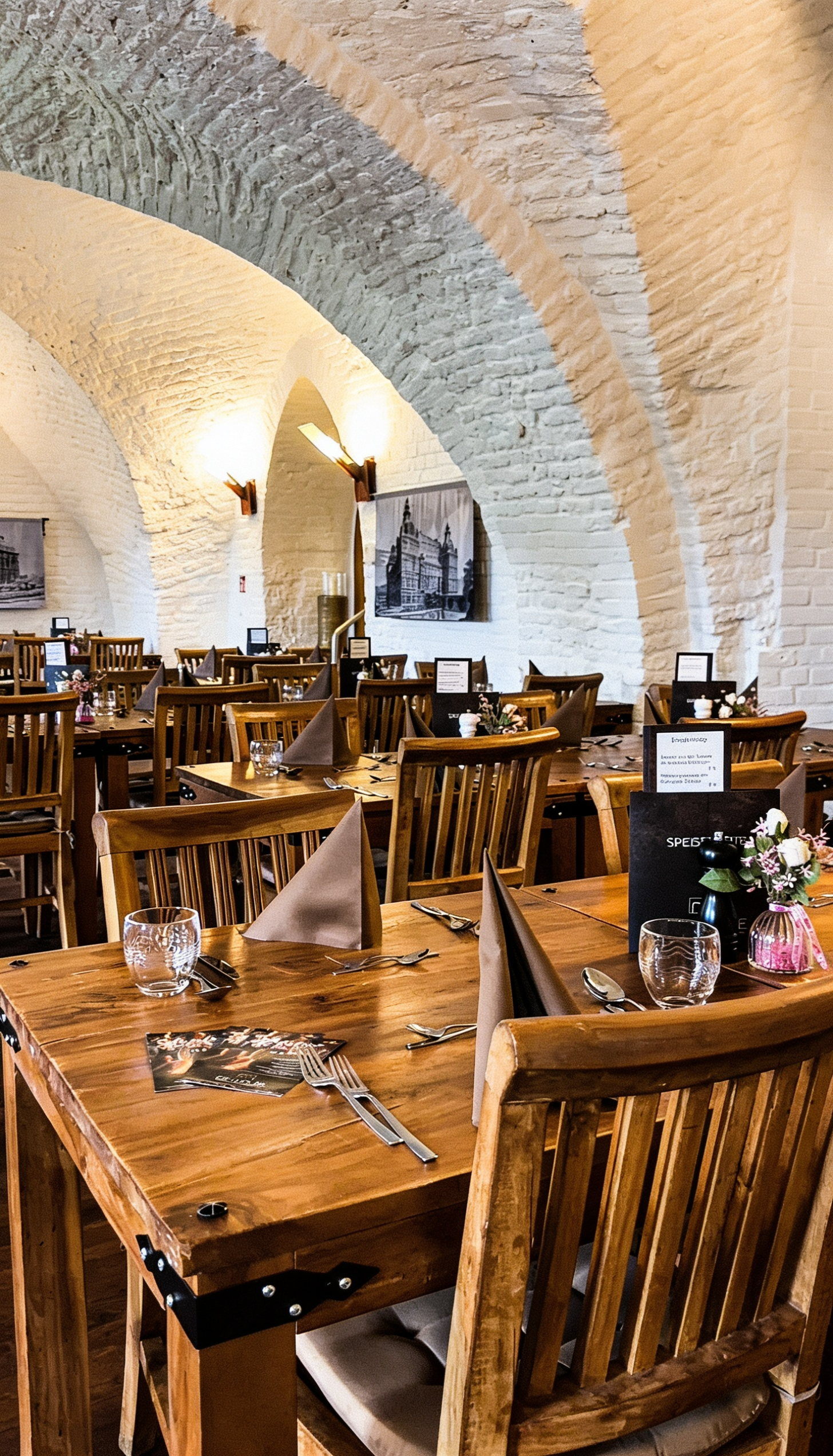 Restaurantambiente im Gewölbe Gelsenkirchen – historische Gewölbearchitektur mit stilvoll gedeckten Holztischen und gemütlicher Atmosphäre