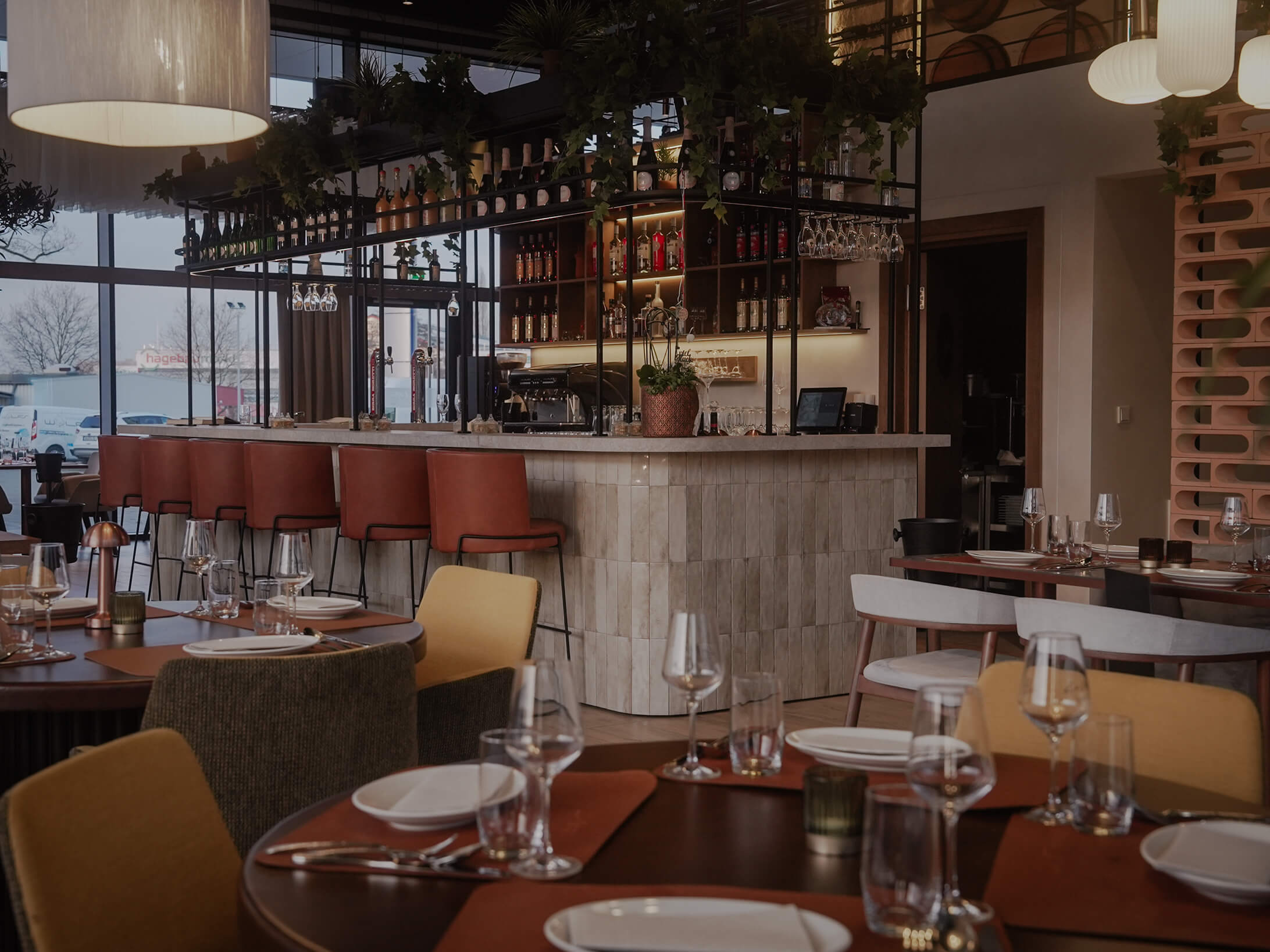 Moderner Barbereich im Ristorante La Vetra mit stilvoll gedeckten Tischen und großer Fensterfront bei Tageslicht