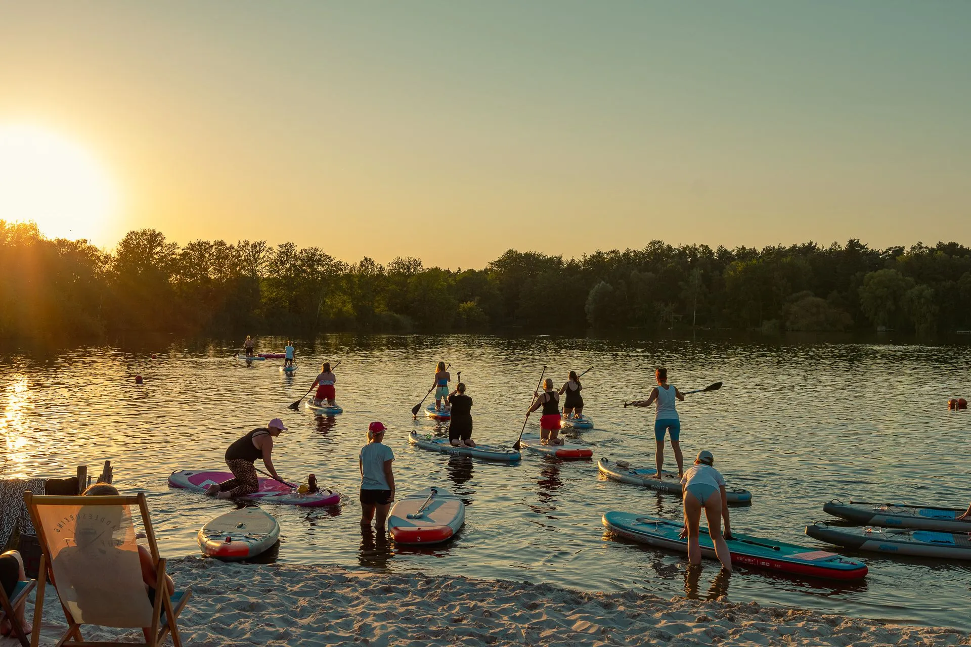 Stand-up-Paddling auf dem Halterner See bei Sonnenuntergang mit mehreren Paddlern