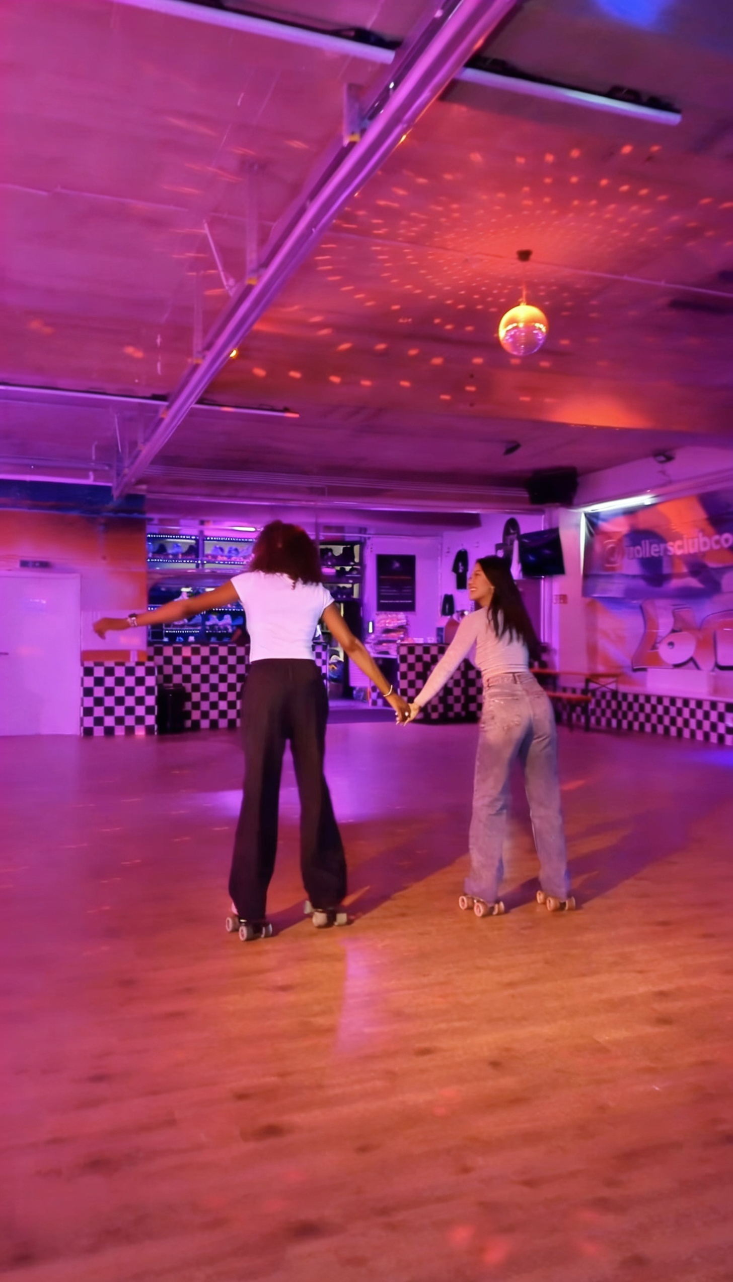 Zwei Personen beim Roller Skating im Rollers Club Köln – Indoor Rollschuhspaß mit Disco Atmosphäre und Neonbeleuchtung